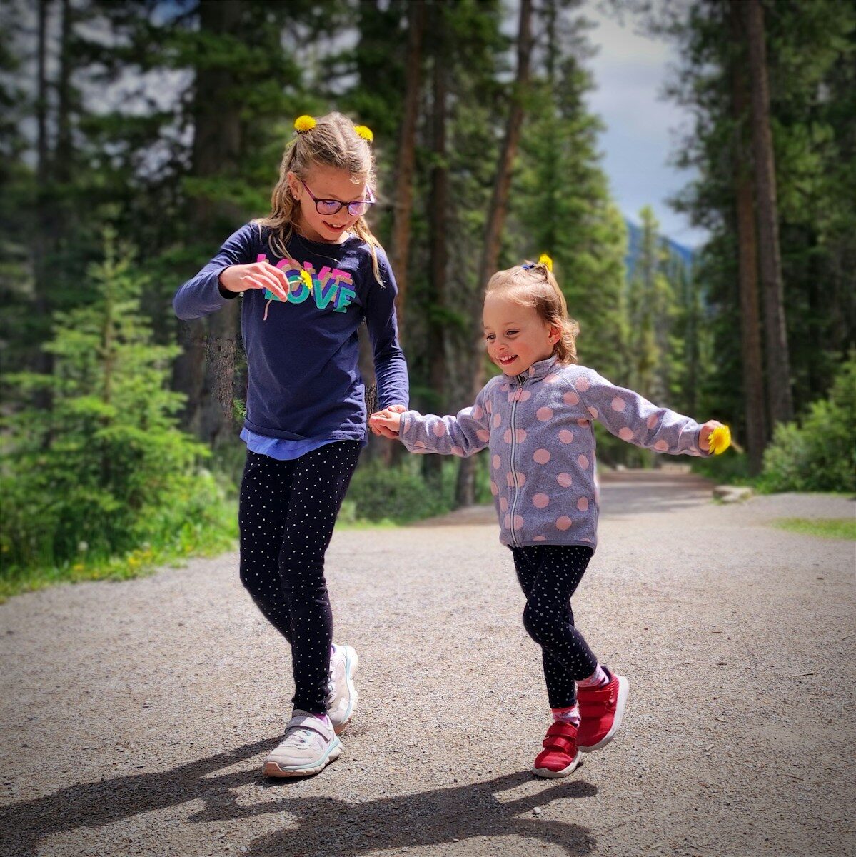 a person and a girl running on a road